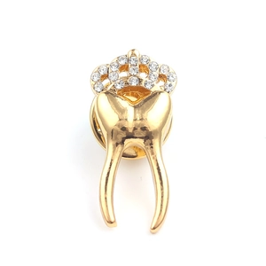 Golden tooth brooch featuring a sparkling rhinestone crown for medical accessories
