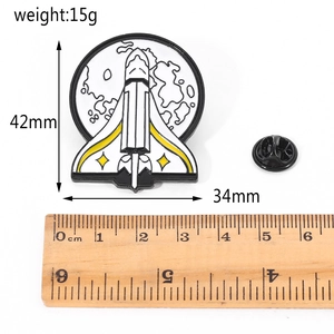 Space shuttle enamel pin with dimensions 42x34mm and weight 15g shown on white background