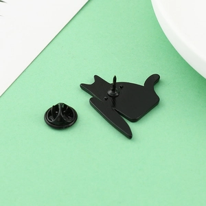 Detail view of the black killer cat enamel pin back with secure rubber clutch backing