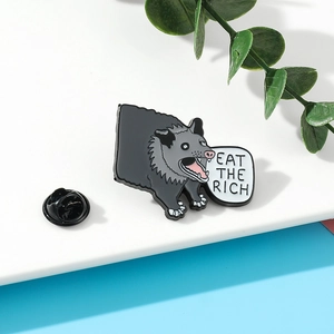 Detail of Eat The Rich enamel pin featuring a cartoon character with a butterfly clutch back