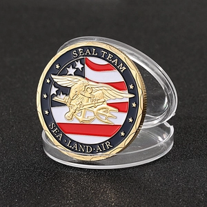 Macro shot of Seal Team challenge coin with eagle anchor design and blue display case