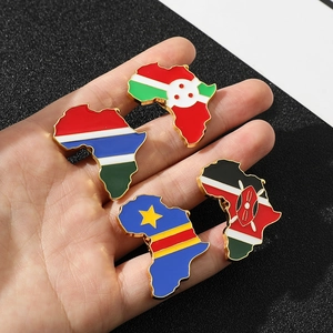 Detail of hand-held African map enamel pins featuring national flags on gold metal bases