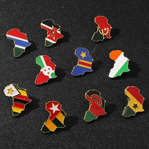 Flat lay of gold-bordered African map enamel pins featuring various national flags