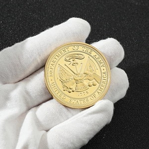 Macro detail of golden US Army commemorative coin featuring embossed eagle and military crest
