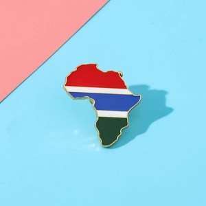 Detailed macro view of an Africa map brooch with colorful stripes and gold metal edges