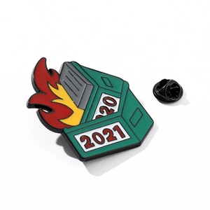 Dumpster fire enamel pin featuring 2020 and 2021 years in a green metallic finish