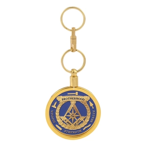 Detail of golden Freemason keychain with blue enamel and engraved brotherhood motto