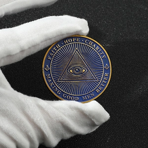 Detailed close-up of custom Masonic challenge coin with eye of providence and gold enamel finish