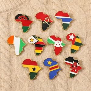 Detail view of African map flag pins displayed on a textured beige knitted sweater fabric