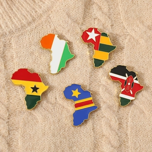 Detail of five African map enamel pins with national flags on a beige knit sweater