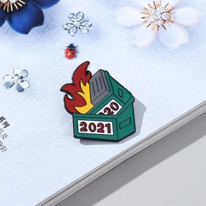 Dumpster fire 2021 enamel pin with green bin and colorful flames on a floral background