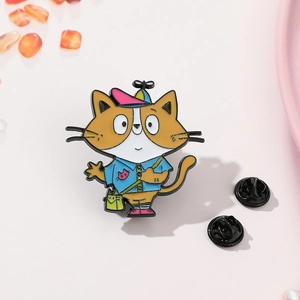 Detail of cartoon cat enamel pin with propeller hat and green crossbody bag on pink backdrop
