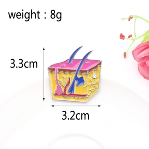 Detail view of anatomy skin layers enamel pin with size specs 3.3cm height 3.2cm width