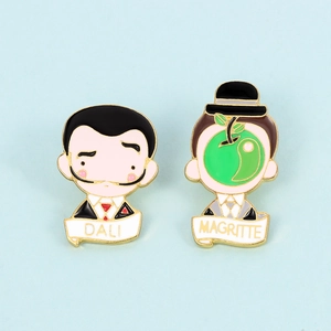 Detail of Salvador Dalí and René Magritte enamel pins with signature artistic elements