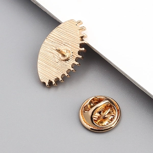 Close-up of golden butterfly clutch pin back with textured base for brooch parts
