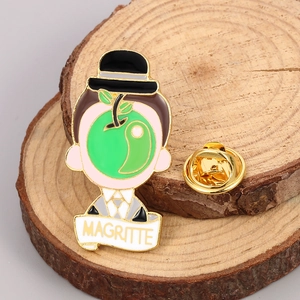 Detailed enamel pin featuring Magritte The Son of Man design on a rustic wood background