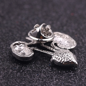 Detail of silver alloy organ brooch back featuring a secure butterfly clutch fastener