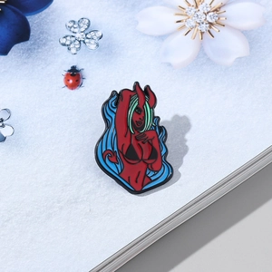 Cartoon little devil enamel pin with red skin and blue flames for bags and clothes