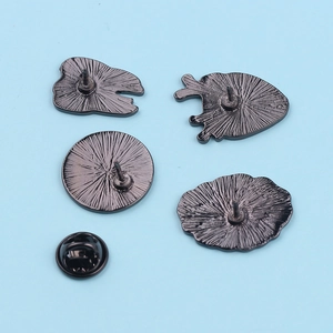 Detailed back view of enamel organ pins showing matte black metal finish and butterfly clutch