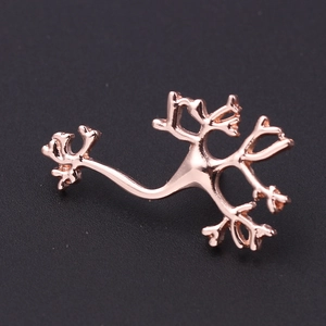 Macro view of rose gold neuron pin featuring detailed biological cell structure