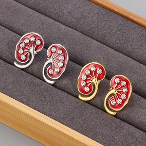 Detailed pair of anatomical kidney pins in gold and silver finish with red enamel and rhinestones