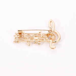 Detail view of the secure safety pin clasp and gold plating on the musical note brooch