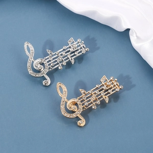 Elegant musical note brooch set with sparkling crystals in gold and silver finishes