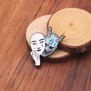 Detailed view of Onimusha enamel pin showing mask opening to reveal Hannya demon on wood