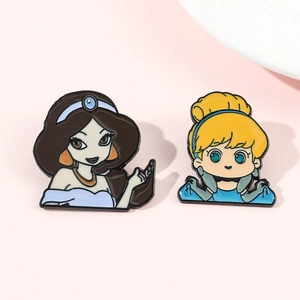 Detail of cartoon enamel pins featuring Cinderella and Jasmine with gold finish lines