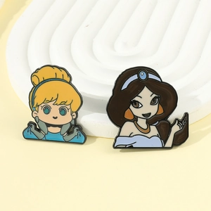 Macro shot of Cinderella and Jasmine enamel badges on a clean white display stand