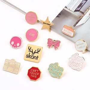 Flat lay of colorful enamel pins with fun quotes on white background and magazine