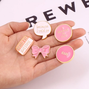 Detailed close-up of a 5-piece pink enamel pin set with motivational quotes and gold edges