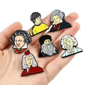 Detailed close-up of cartoon enamel pins set featuring Einstein and Beethoven portraits