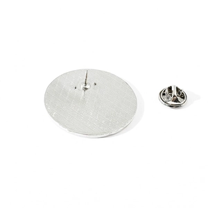 Detail of metal pin back with butterfly clutch and textured anti-slip grid surface