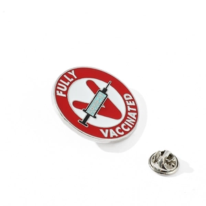 Detailed close-up of Fully Vaccinated COVID-19 enamel pin with red V and syringe design