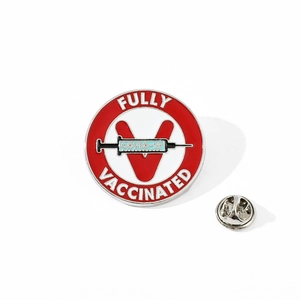 Detail of COVID-19 fully vaccinated enamel pin with syringe design and butterfly clutch