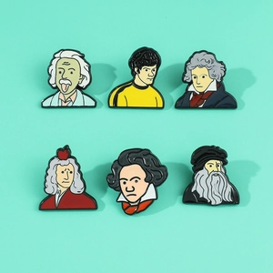 Detailed close-up of six creative enamel pins featuring cartoon historical figures on green