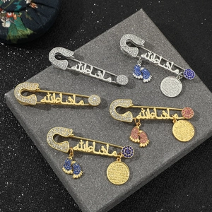 Detailed set of gold and silver pins with rhinestones, Arabic scripts and foot charms
