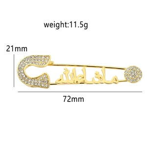 Golden safety pin brooch with sparkling rhinestones and Arabic calligraphy design
