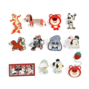 Collection of cartoon enamel lapel pins featuring Disney characters on white backdrop