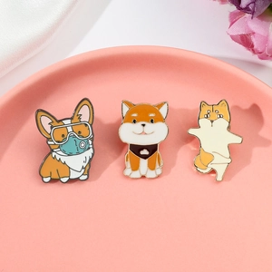 Detailed view of three cute enamel dog pins featuring Corgi and Shiba Inu designs