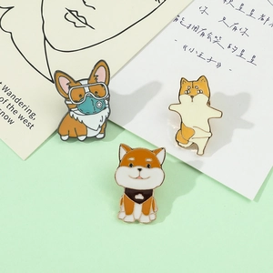 Detailed view of three cute cartoon dog enamel pins on a decorative card background