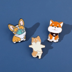 Three cartoon shiba inu and corgi enamel pins on a dark blue background for bags