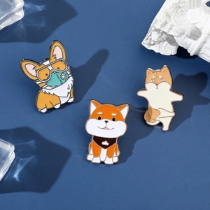 Detail of cute enamel pins featuring Corgi and Shiba Inu designs for backpacks