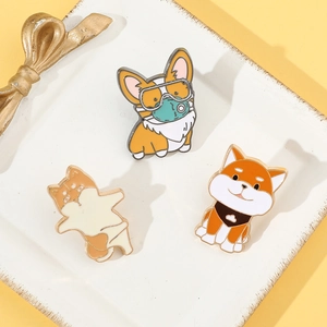 Detailed close-up of three cute enamel dog pins including Corgi and Shiba Inu designs