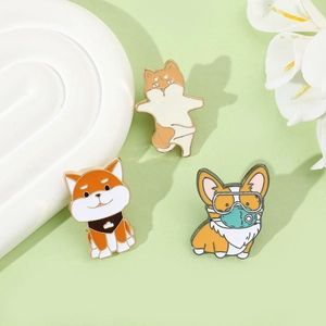 Detail view of cartoon Shiba Inu and Corgi enamel pins on a decorative ceramic tray
