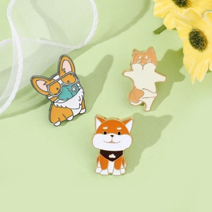 Three cute enamel dog pins including Corgi and Shiba Inu on a soft green background