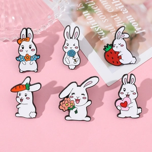 Set mit sechs süßen Cartoon-Hasen-Emaille-Pins in verschiedenen Posen auf Rosa