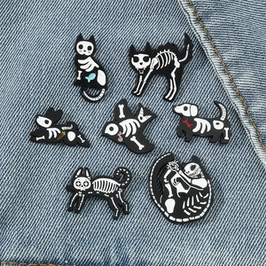 Gothic skull animal enamel pin set featuring cat, dog and bird skeletons on denim background