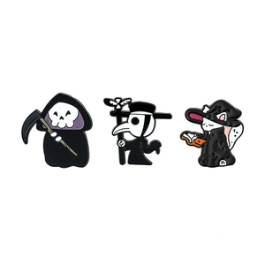 Detail of cartoon enamel pins featuring Grim Reaper, Plague Doctor, and Wizard cat